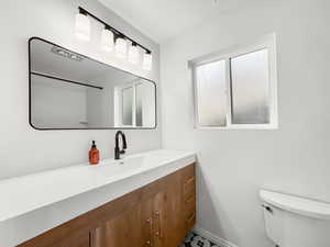 Bathroom featuring vanity and toilet