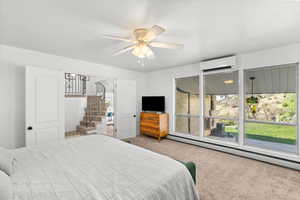 Carpeted bedroom featuring a baseboard radiator, a ceiling fan, and a textured ceiling