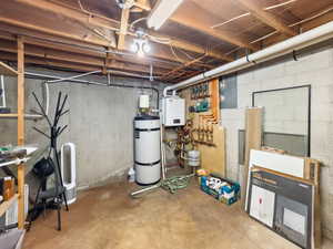 Unfinished below grade area featuring secured water heater and a heating unit