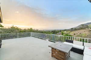 Patio terrace at dusk with a patio area and outdoor furniture