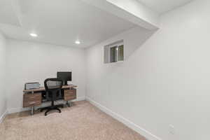 Office area with light colored carpet and recessed lighting