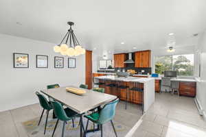 Dining area featuring an office area, recessed lighting, light tile patterned floors, and a baseboard radiator
