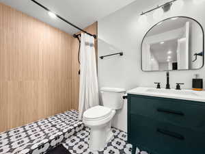 Full bathroom featuring vanity and a shower with shower curtain