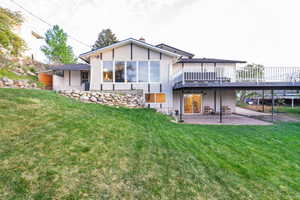 Back of property featuring a patio area and a yard