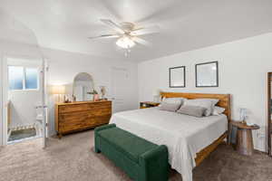 Bedroom with carpet floors, a ceiling fan, ensuite bathroom, and a textured ceiling