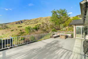 Wooden terrace with outdoor lounge area and a mountain view