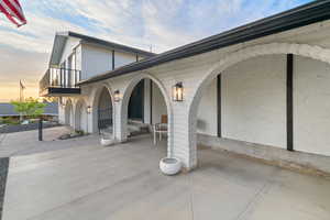 View of side of property featuring stucco siding and a balcony