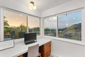 Office space featuring built in desk and a textured ceiling