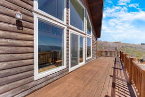 Expansive outdoor deck featuring wood flooring and matching wood railing