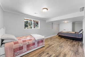 Spacious room featuring wood-finish flooring, light grey walls, and a large window with a mountain backdrop