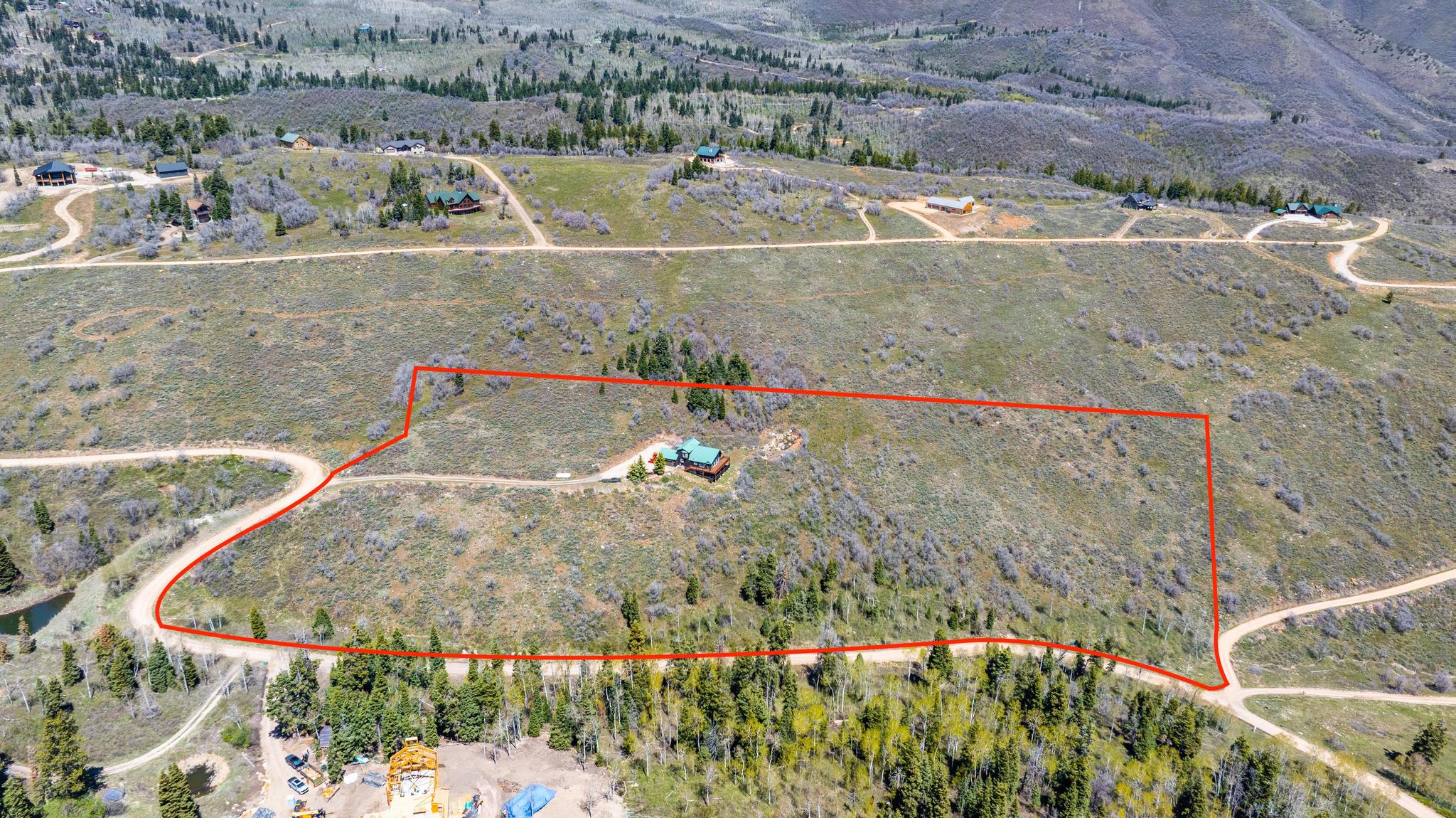 Expansive land parcel featuring natural terrain and established trees