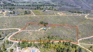 Expansive land parcel featuring natural terrain and established trees