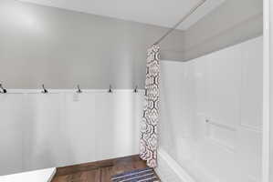 Full bathtub and shower combination with white surround