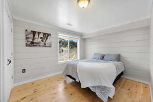 Room featuring shiplap accent walls and light wood-finish flooring