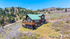 Wood-sided home with a green metal roof