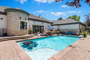 Pool featuring a built-in seating area and table