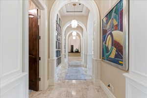 Light-filled hallway featuring a series of arches