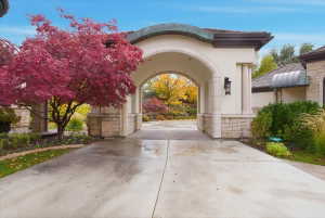 Arched porte-cochere with covered drive-through and walkway to private guest house