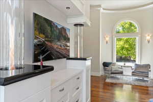 Main floor Primary suite features glass -encased vertical flame columns