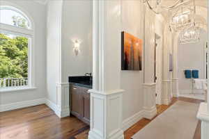 Hallway leading from primary bedroom to dual closets and spa bath