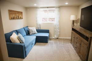 Living room featuring light colored carpet and recessed lighting