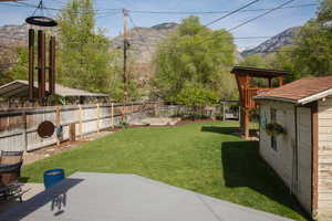 Fenced backyard with a mountain view