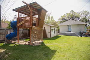 Back of house featuring a tree house