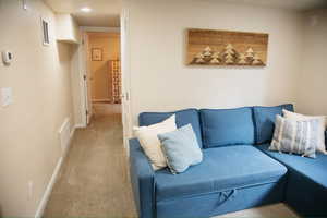 Living area featuring carpet floors and baseboards