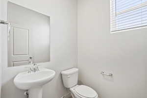 *DISCLAIMER*  Interior package and colors may vary. Bathroom featuring toilet and a sink