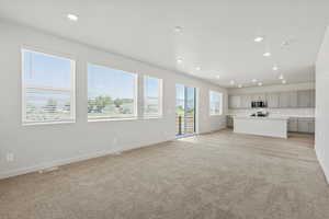 *DISCLAIMER*  Interior package and colors may vary. Unfurnished living room featuring light carpet and recessed lighting