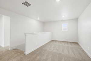 *DISCLAIMER*  Interior package and colors may vary. Unfurnished room with light colored carpet and recessed lighting