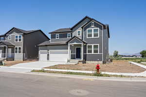 View of front of property featuring concrete driveway, board and batten siding, a garage, and entry steps