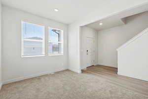 *DISCLAIMER*  Interior package and colors may vary. Entrance foyer featuring recessed lighting and light carpet