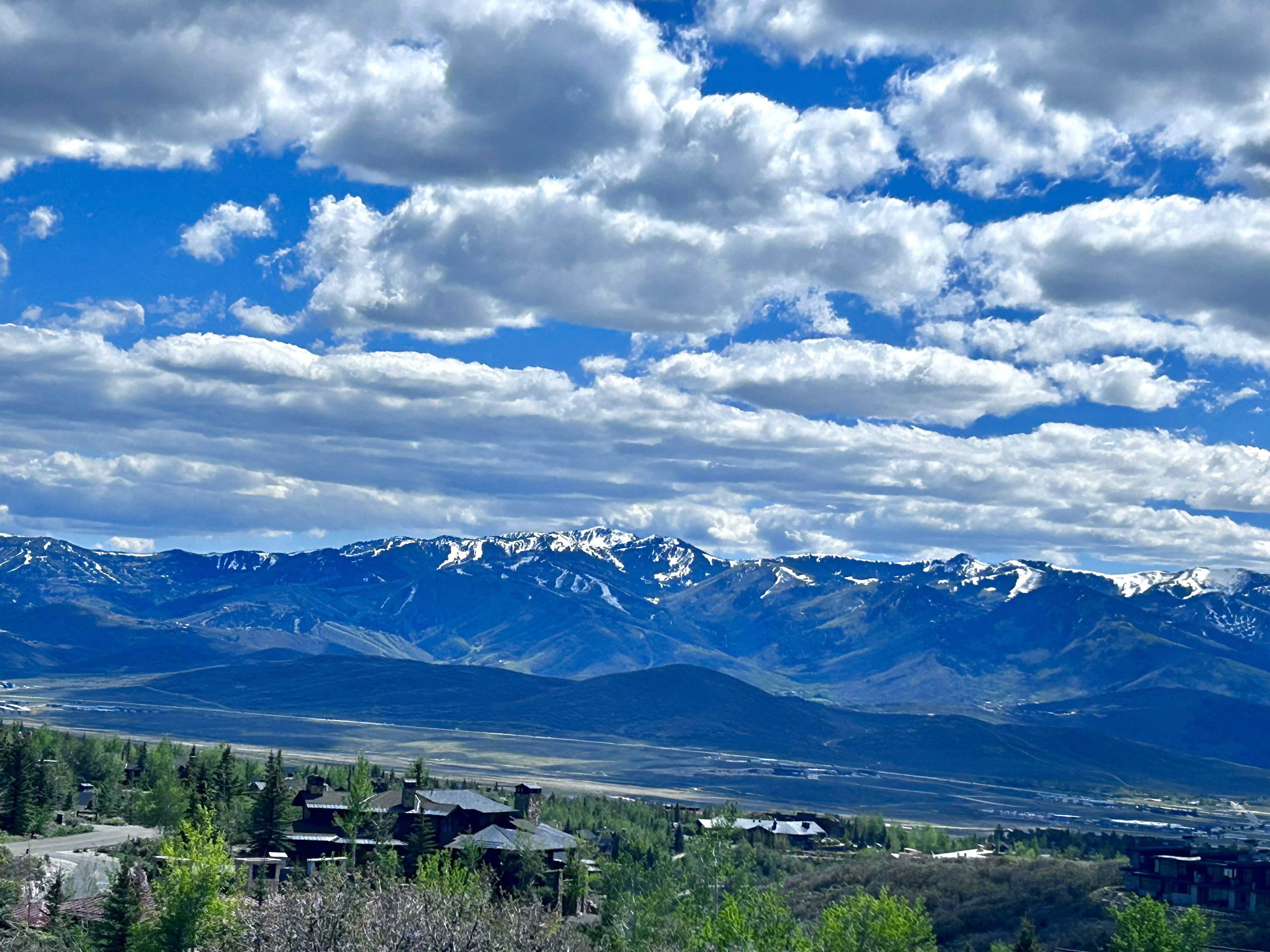 Expansive mountain range backdrop with snow-capped peaks