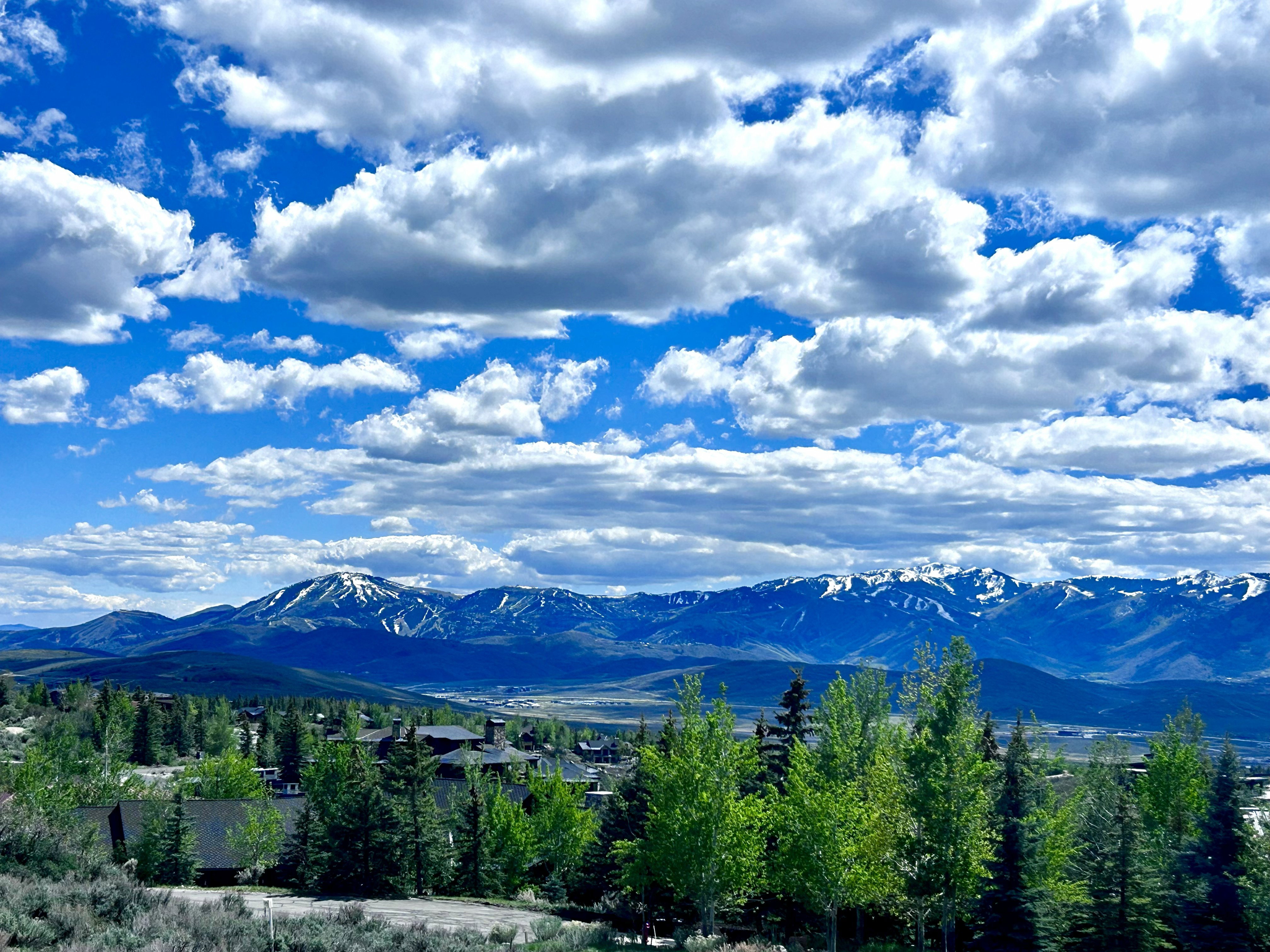 Expansive mountain scenery featuring snow-capped peaks and a valley below