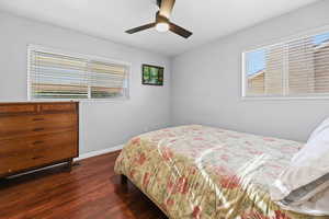 Bedroom featuring dark wood-style floors and ceiling fan