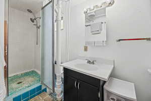 Bathroom with a shower stall and vanity