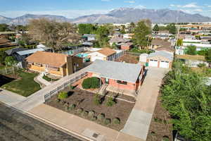 Aerial view of residential area featuring a mountainous background