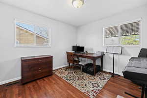 Office area featuring dark wood-type flooring