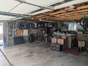 Garage featuring a workshop area and electric panel
