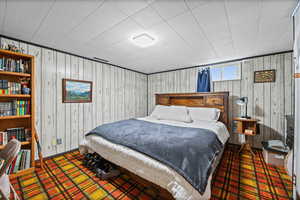 Bedroom with wooden walls