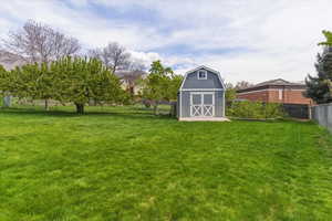 Fenced backyard with a storage shed