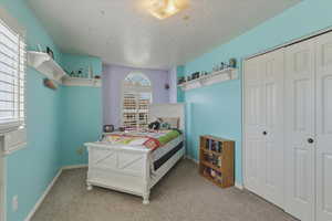 Bedroom with carpet floors and a closet