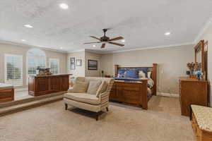 Bedroom with light colored carpet, recessed lighting, crown molding, ceiling fan, and a textured ceiling