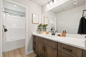 Bathroom featuring vanity, light wood-style floors, and tub / shower combination