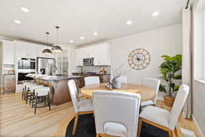 Dining area featuring light wood-style floors and recessed lighting