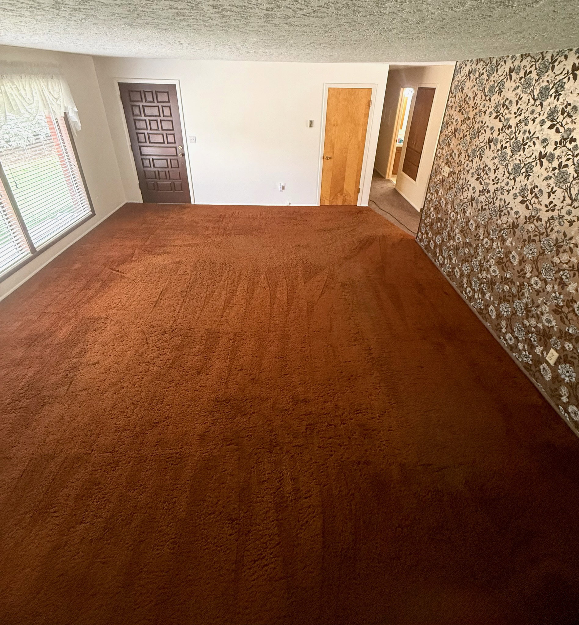 Spare room featuring carpet floors and a textured ceiling