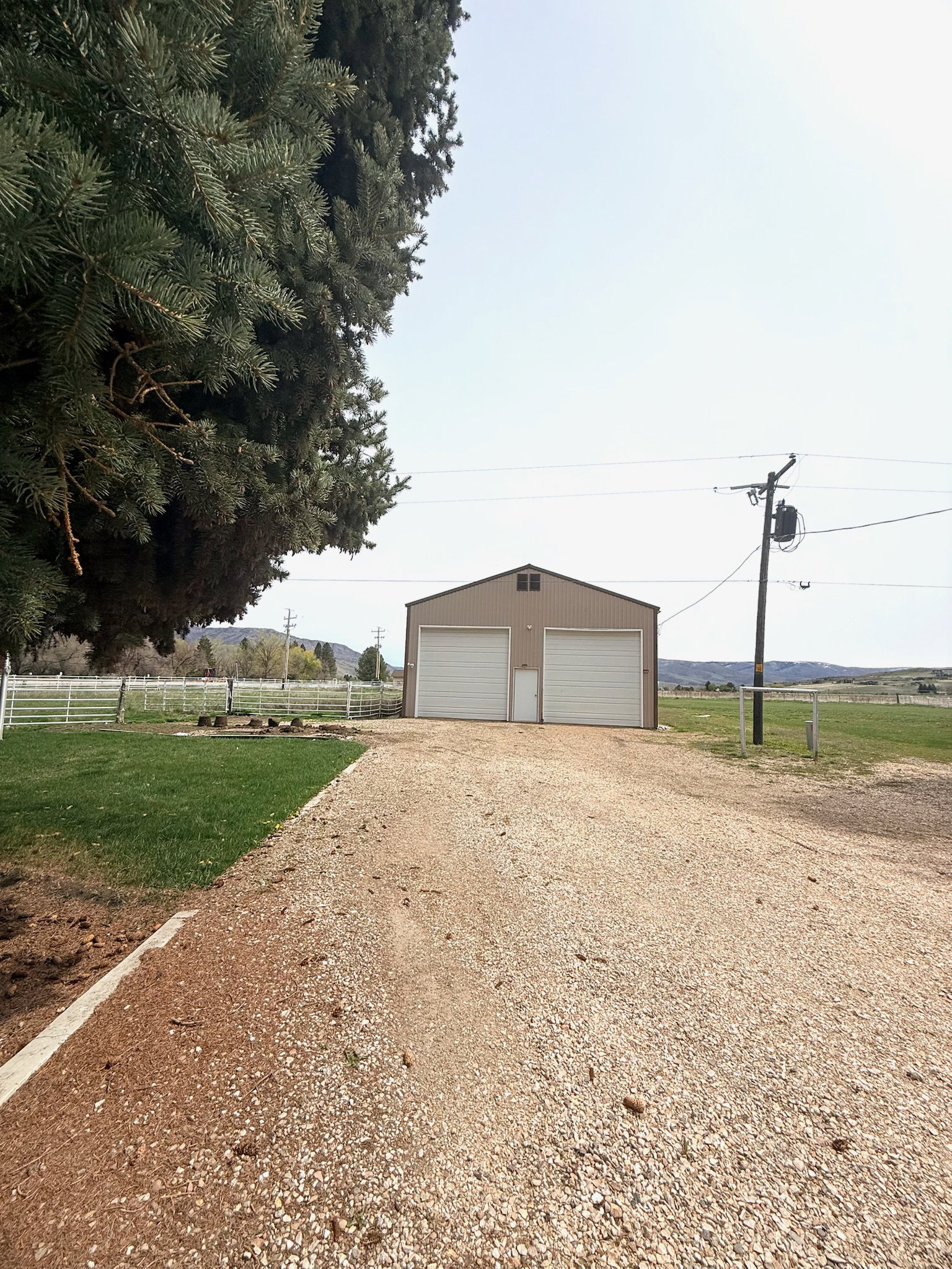 Detached garage featuring a view of countryside
