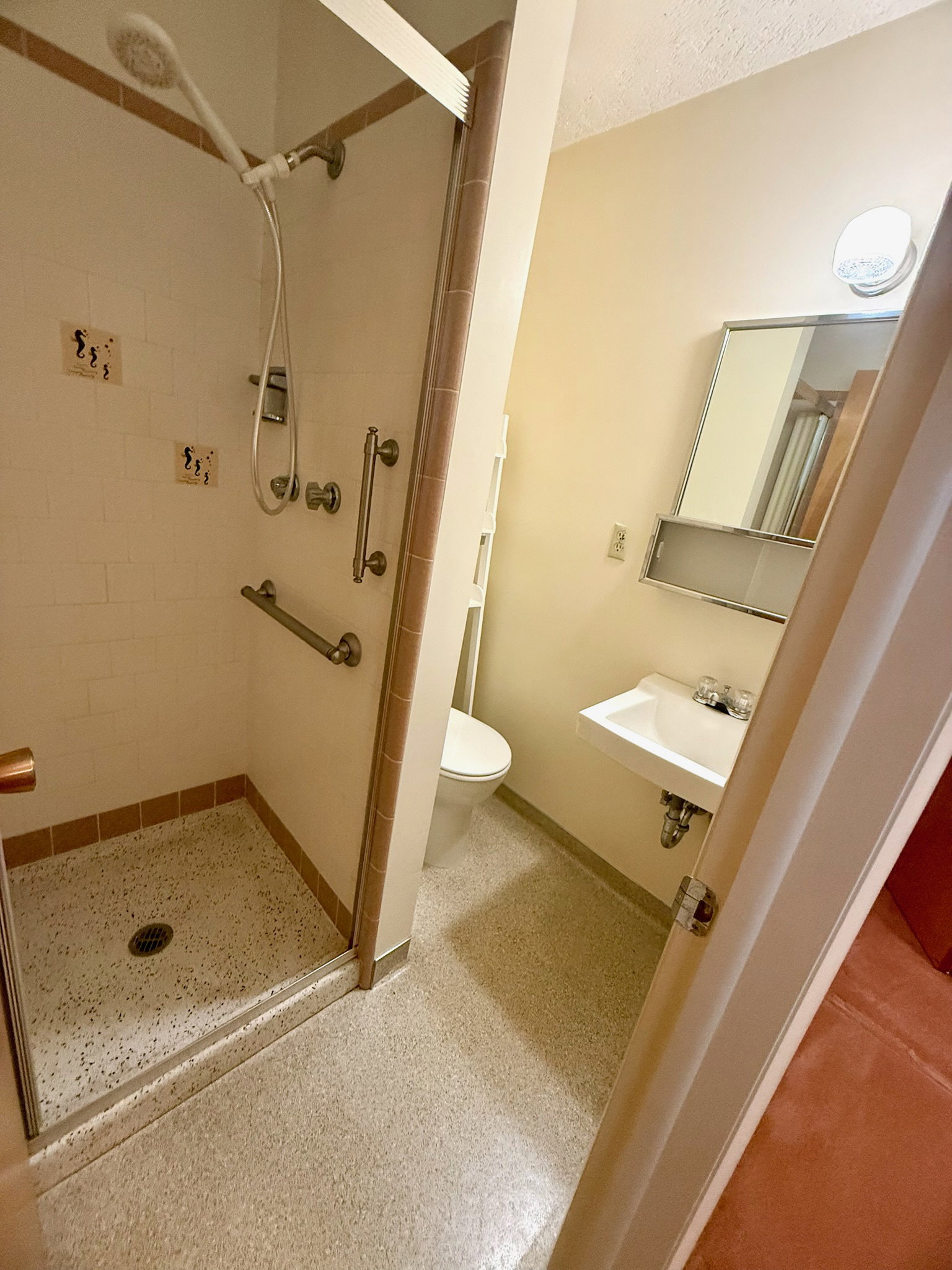 Full bathroom featuring toilet and a stall shower