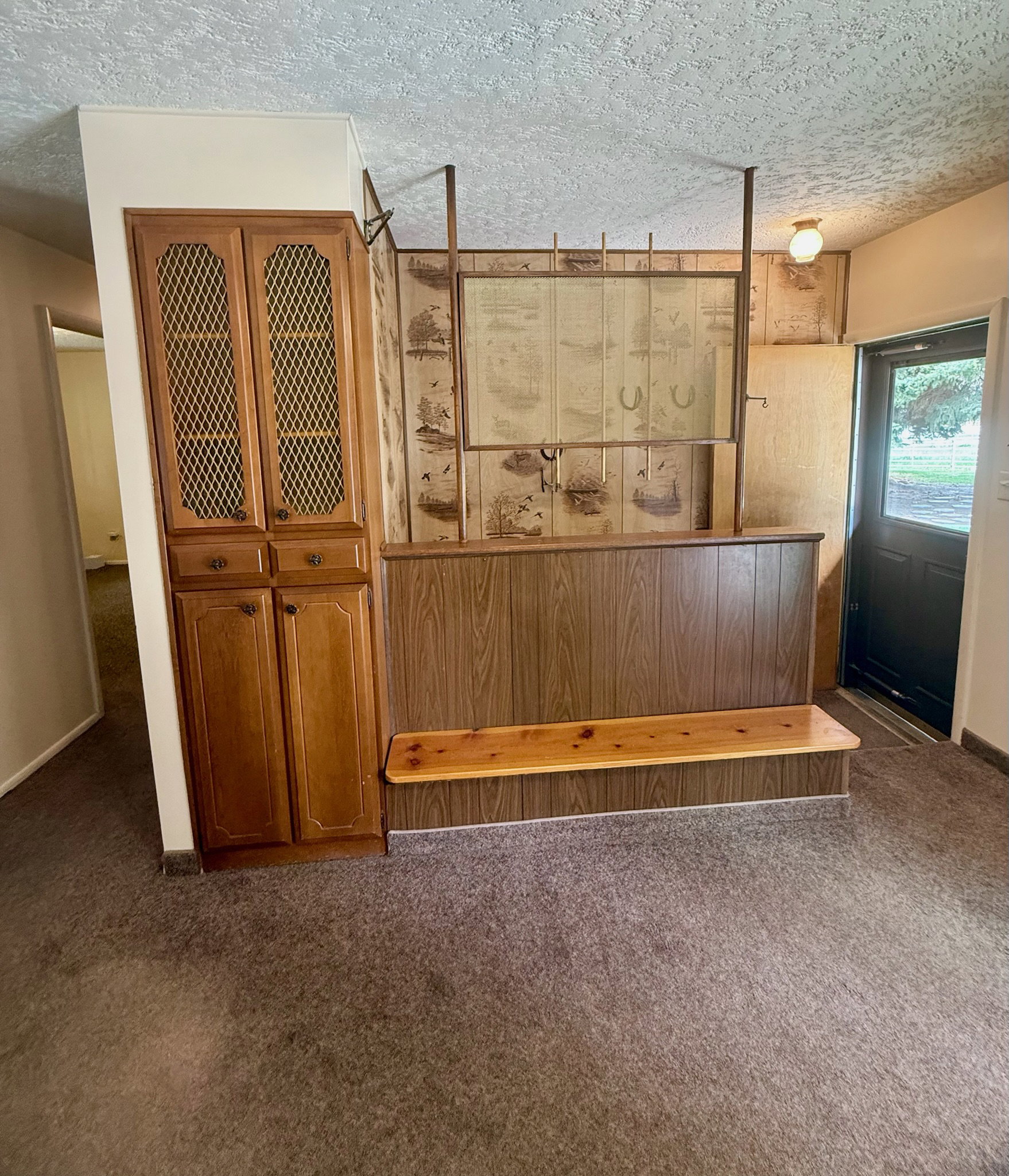 Detailed view of carpet floors and a textured ceiling